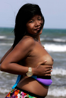 Ethnic girl posing naked on the sea